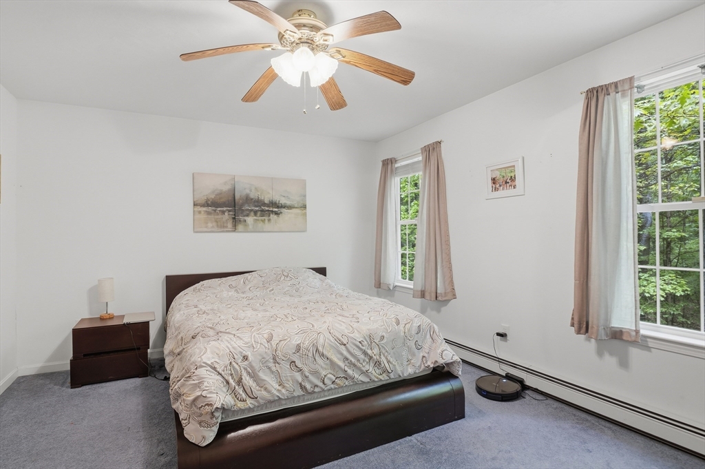 186 Common Street Groton, MA 01450 - Photo 17 of 28 a bedroom with a bed and a window