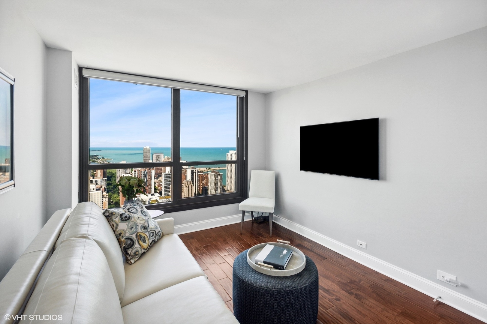 1030 North State Street, Unit 44E Chicago, IL 60610 - Photo 15 of 22 a living room with furniture and a flat screen tv