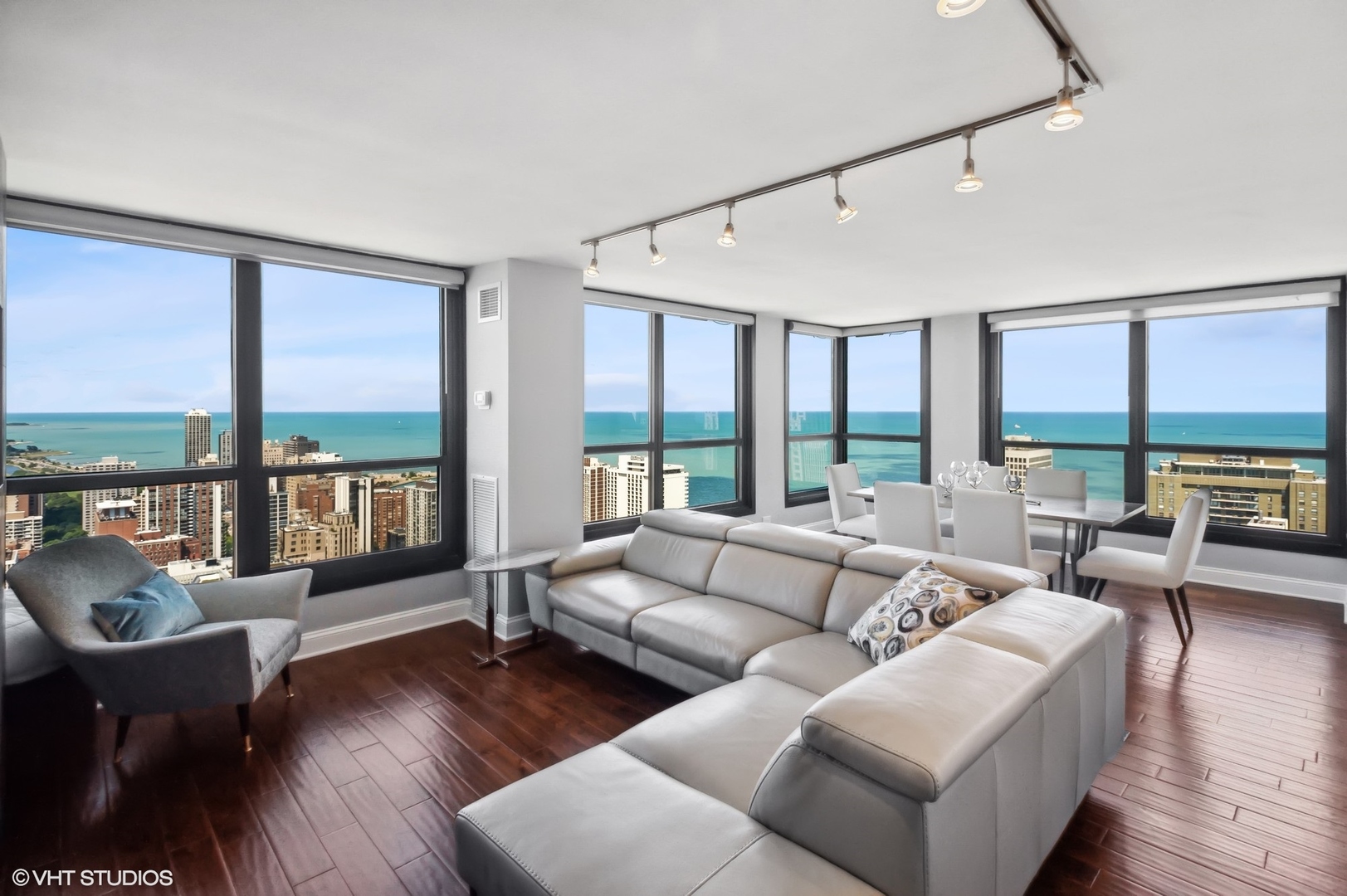 1030 North State Street, Unit 44E Chicago, IL 60610 - Photo 3 of 22 a living room with furniture large windows and wooden floor
