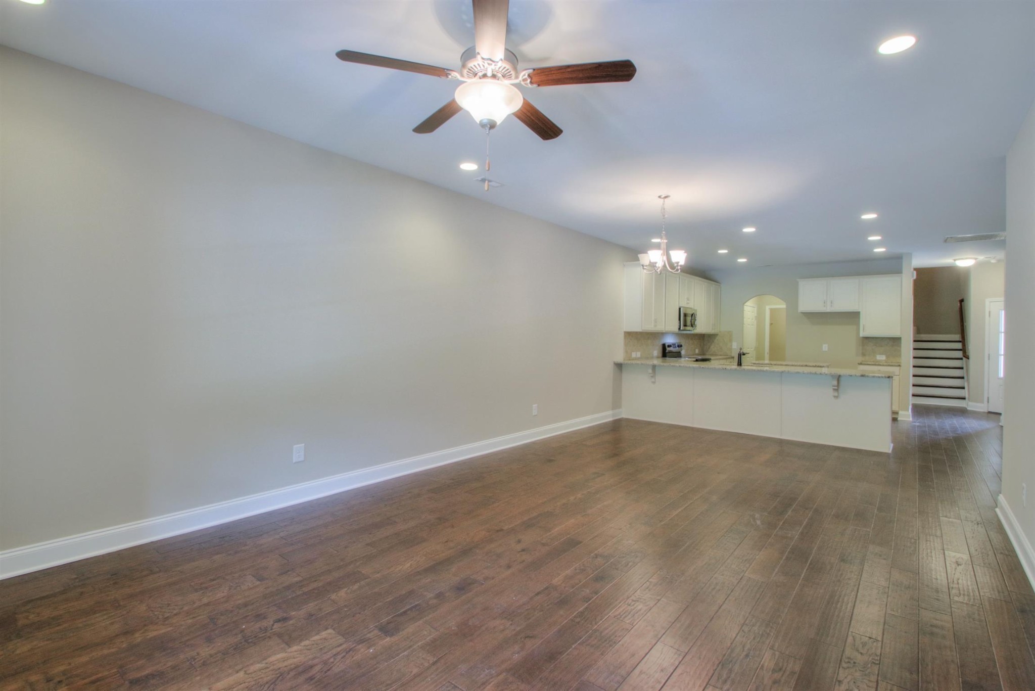 9096 Headwaters Drive Franklin, TN 37064 - Photo 8 of 22 an empty room with wooden floor and windows