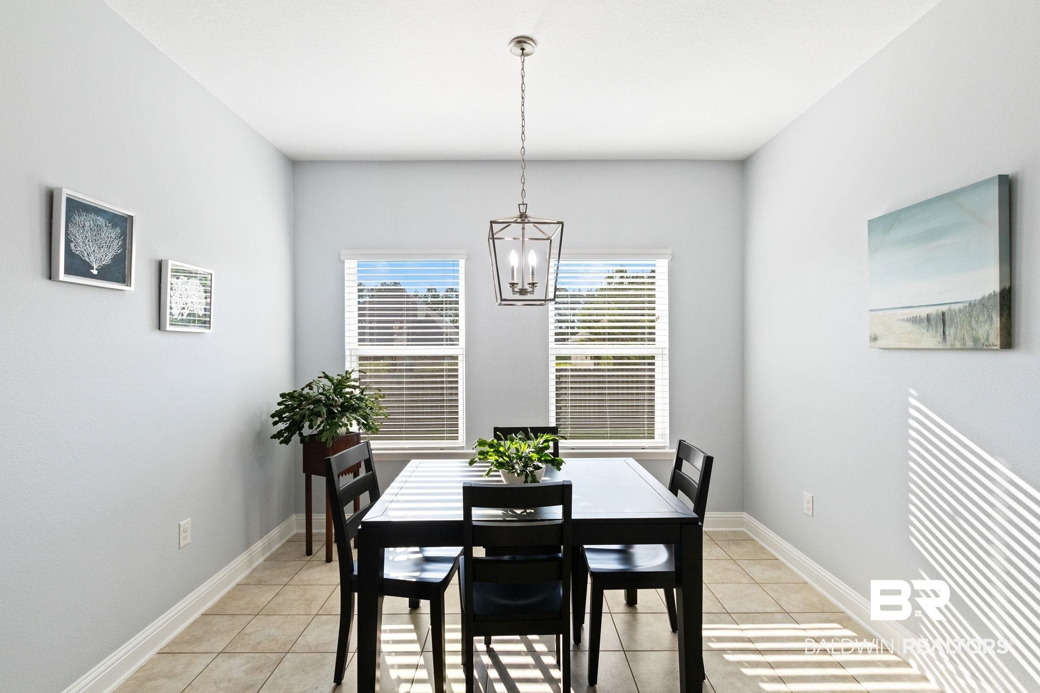 31541 Hoot Owl Road Daphne, AL 36527 - Photo 19 of 51 Tiled dining area featuring a chandelier