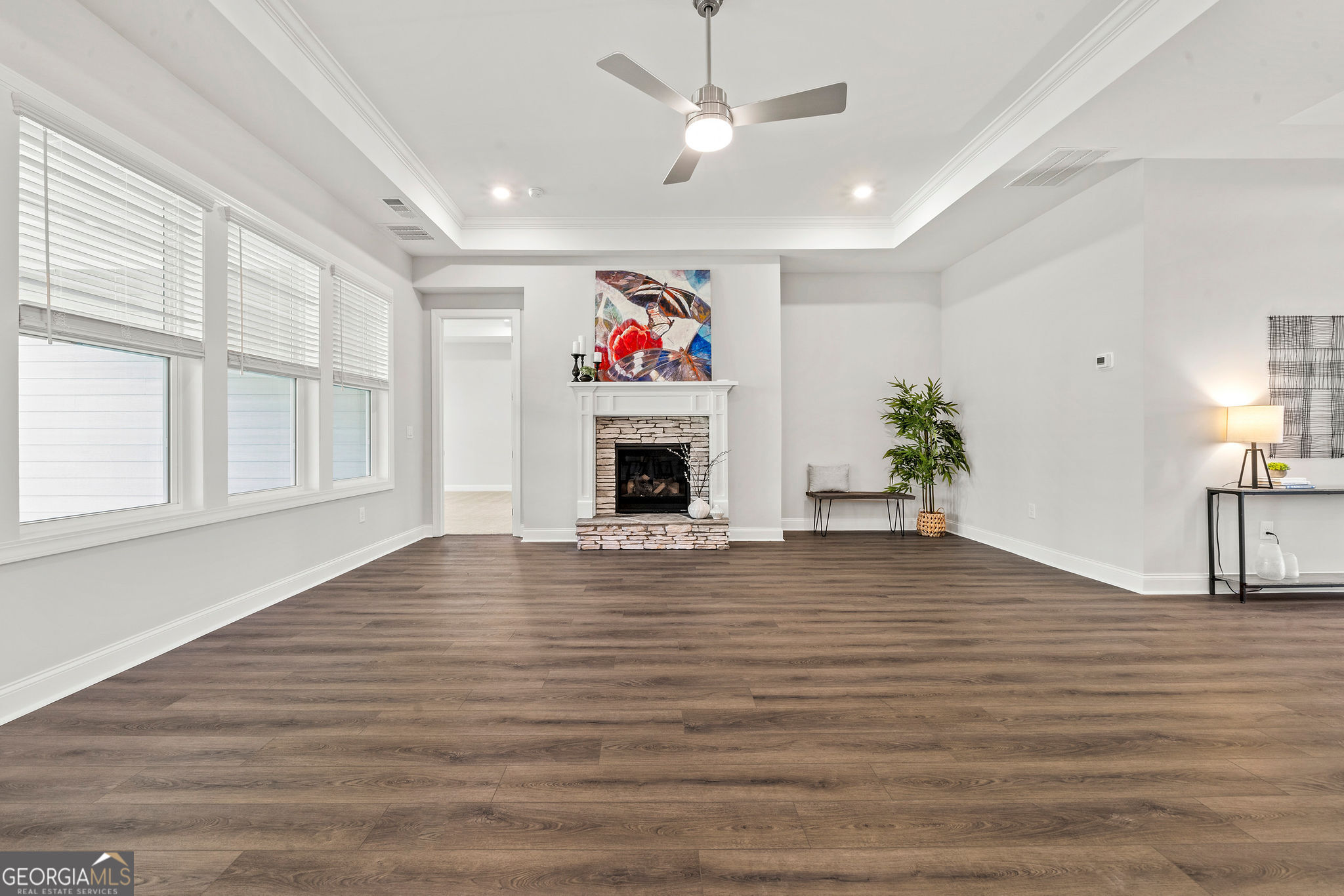 68 Ballyfin Way Newnan, GA 30263 - Photo 17 of 46 a view of an empty room with wooden floor fireplace and a window