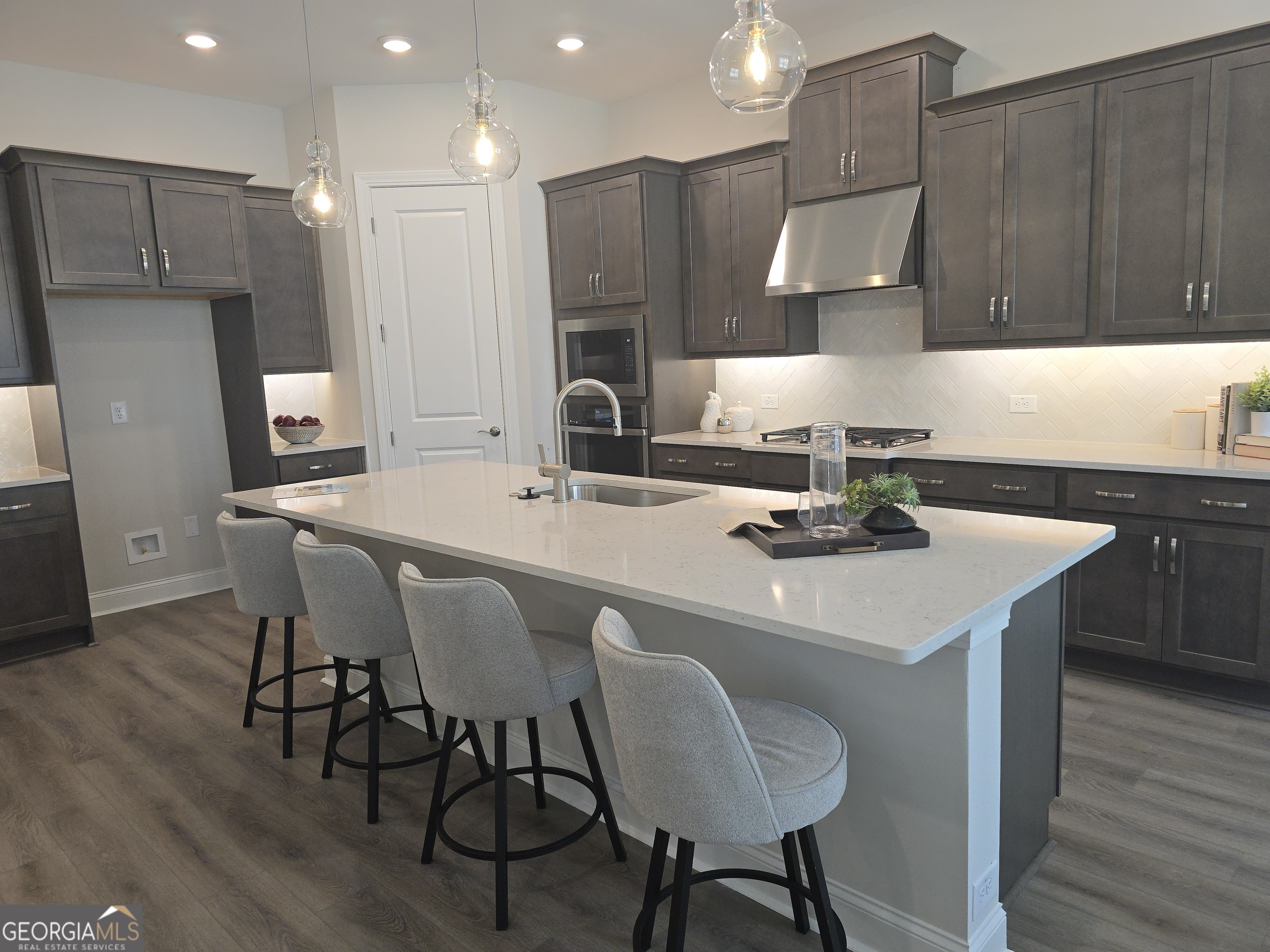 68 Ballyfin Way Newnan, GA 30263 - Photo 2 of 46 a kitchen with stainless steel appliances a sink a table and chairs