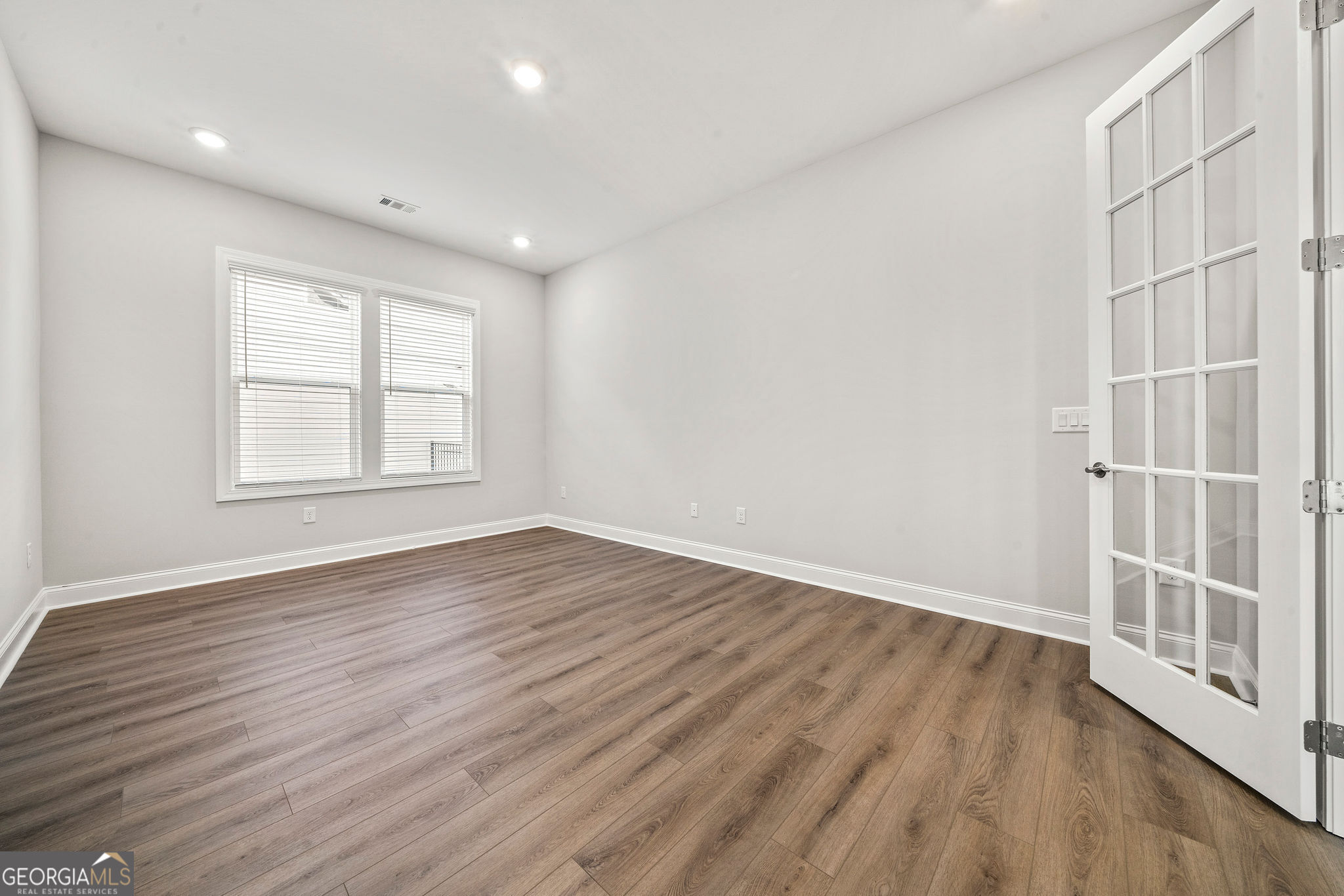 68 Ballyfin Way Newnan, GA 30263 - Photo 28 of 46 wooden floor in an empty room with a window
