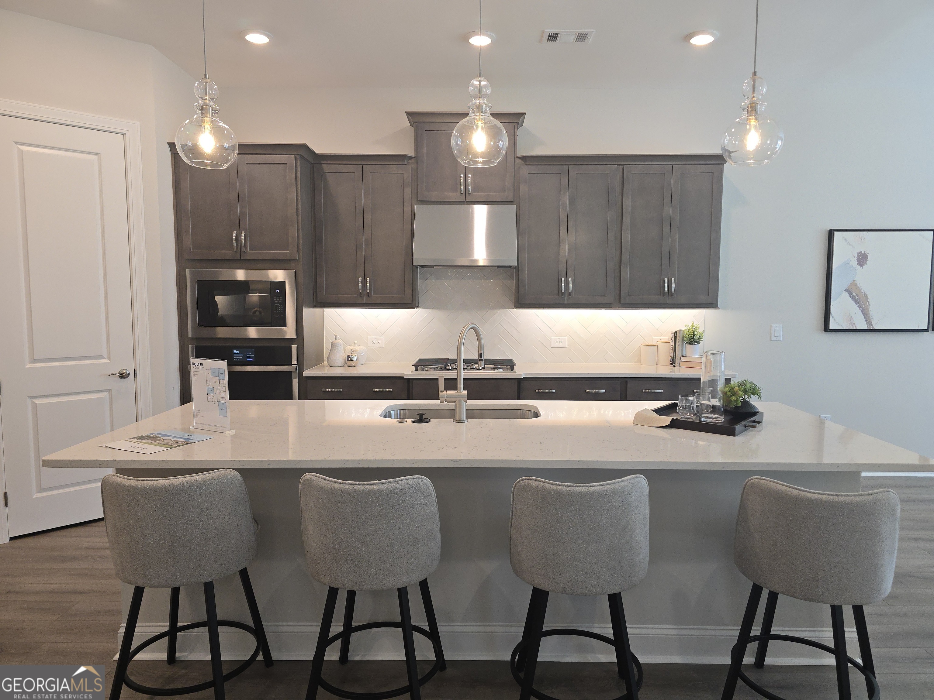 68 Ballyfin Way Newnan, GA 30263 - Photo 4 of 46 a kitchen with a dining table chairs sink and cabinets