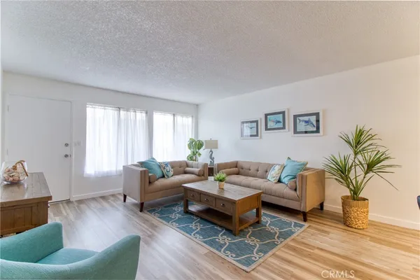a living room with furniture and a potted plant