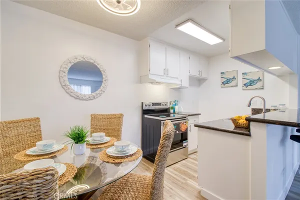 a kitchen with stainless steel appliances kitchen island granite countertop a sink and a stove