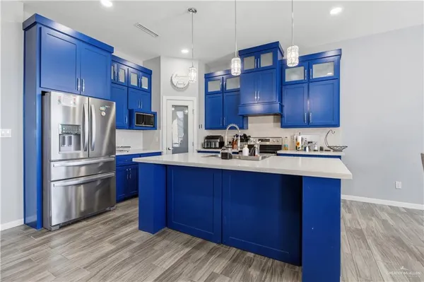 a kitchen with stainless steel appliances granite countertop a refrigerator and a sink