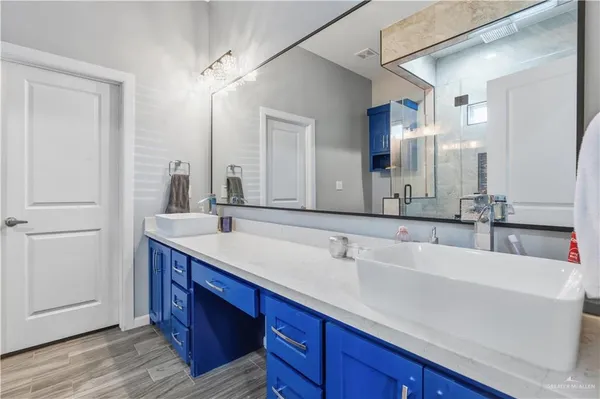 a bathroom with a double vanity sink and a mirror