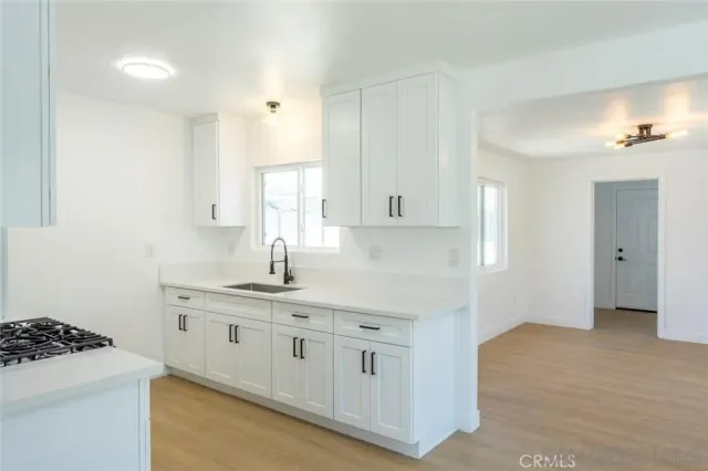 a kitchen with white cabinets and a sink