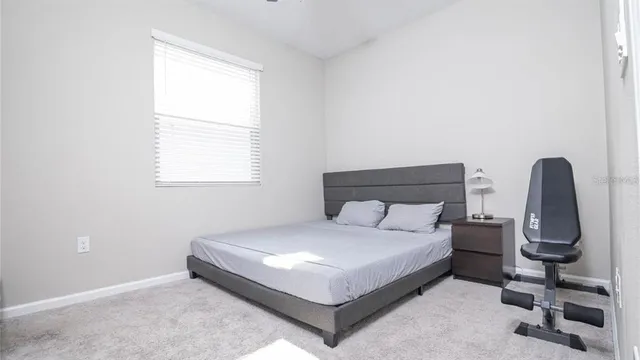 a bedroom with a bed and a chair