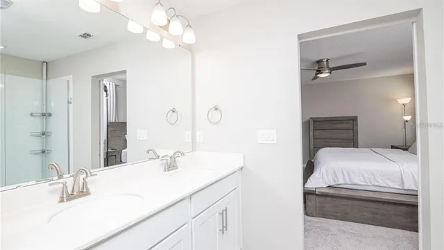 a bathroom with a sink vanity granite and a mirror