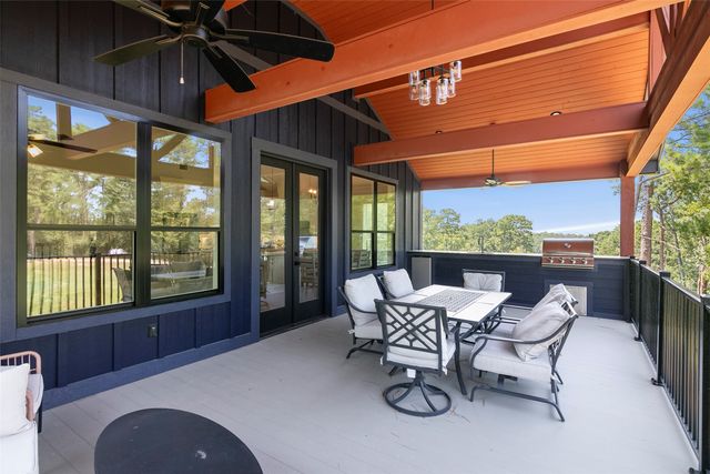 a view of a patio with table and chairs under an umbrella