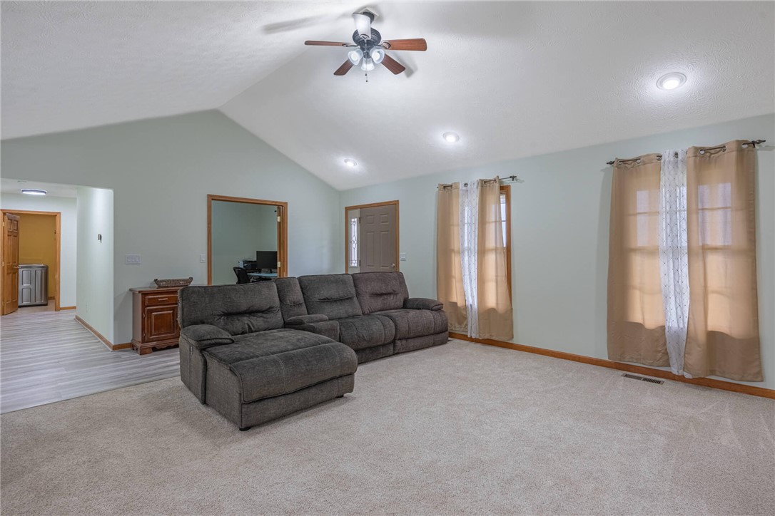 2645 Vance Road St. Paris, OH 43072 - Photo 5 of 35 A spacious living area featuring vaulted ceilings and soft carpeting invites relaxation.