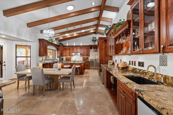 a dining room with furniture potted plants and a chandelier
