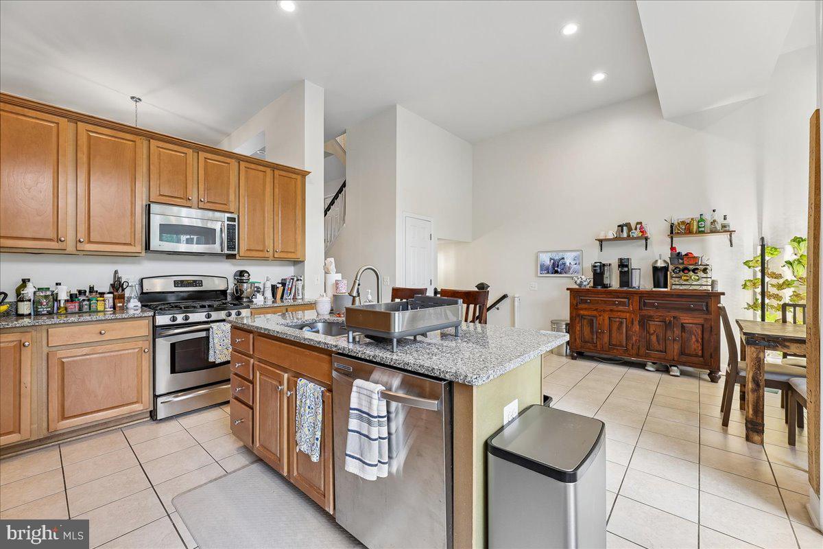 9276 Laurel Ridge Crossing Road Lorton, VA 22079 - Photo 12 of 43 Modern kitchen with warm wood accents.