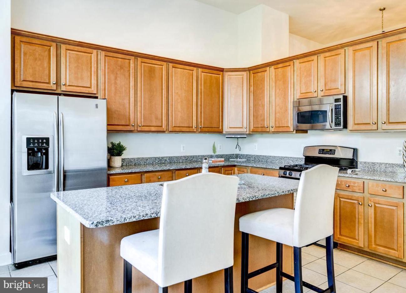 9276 Laurel Ridge Crossing Road Lorton, VA 22079 - Photo 13 of 43 Modern kitchen with warm wood tones.