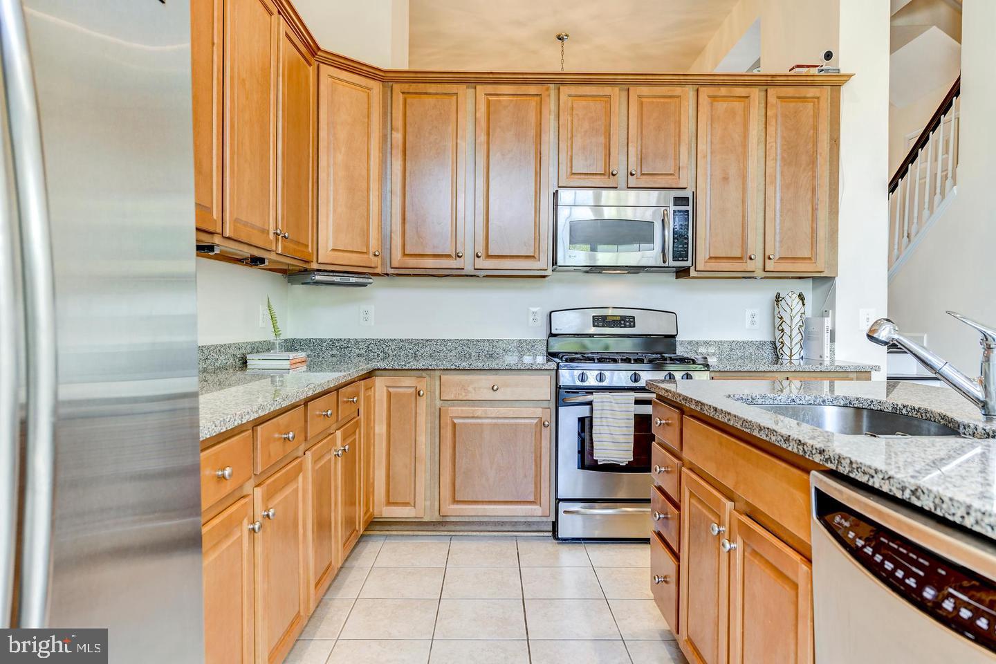 9276 Laurel Ridge Crossing Road Lorton, VA 22079 - Photo 15 of 43 Modern kitchen with warm wood tones.