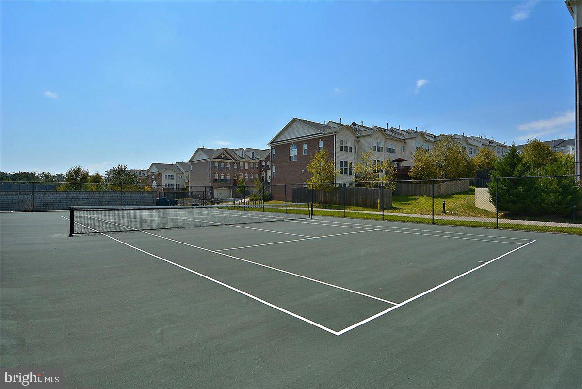 9276 Laurel Ridge Crossing Road Lorton, VA 22079 - Photo 39 of 43 Sunny tennis court with serene backdrop.