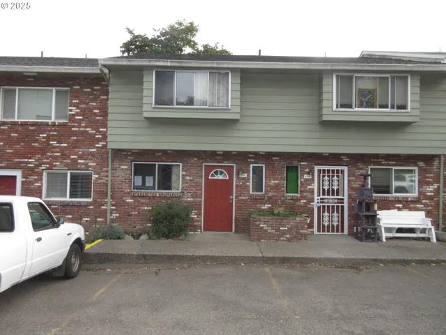 a front view of a house with parking space