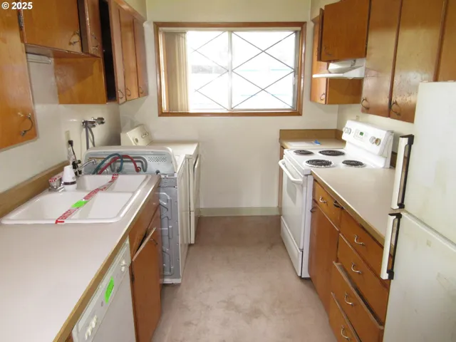 a utility room with a sink dryer and washer