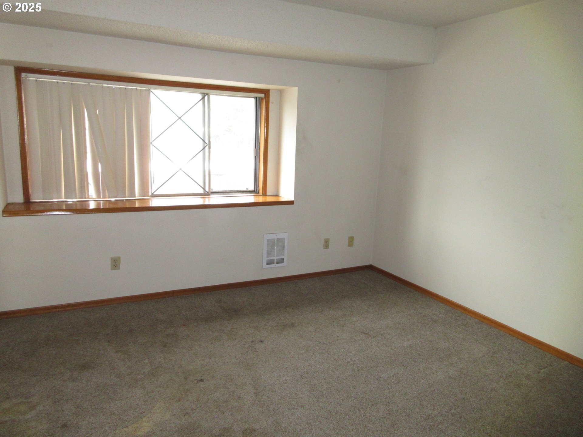 1308 Northeast Hogan Drive, Unit 166 Gresham, OR 97030 - Photo 6 of 13 an empty room with a window