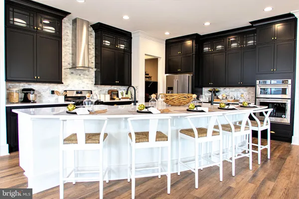 a kitchen with stainless steel appliances kitchen island granite countertop a sink and cabinets
