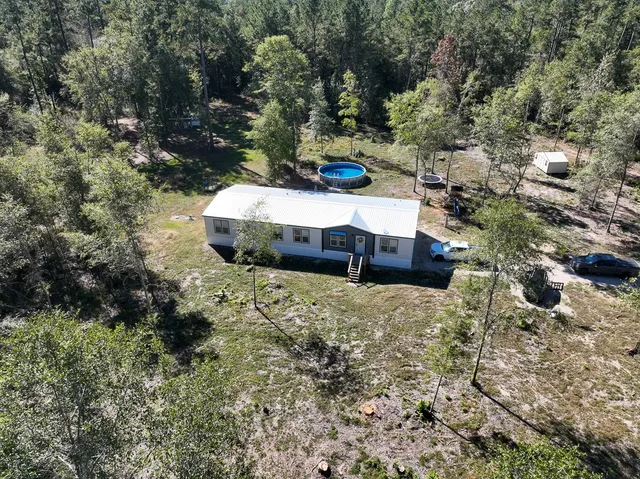 aerial view of a house with a yard