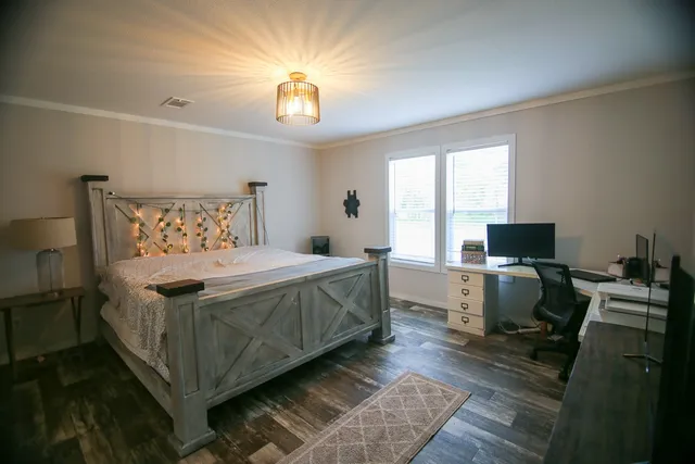 a bedroom with a bed and a desk