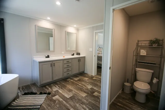 a bathroom with a toilet sink and mirror