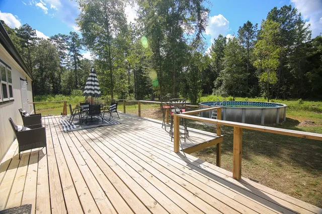 swimming pool view with a seating space