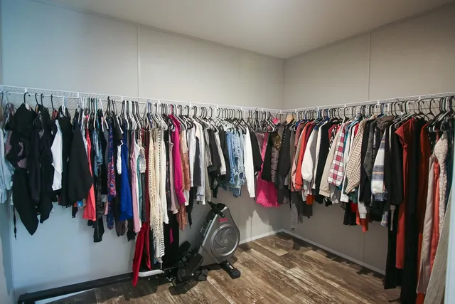 a view of walk in closet with clothes