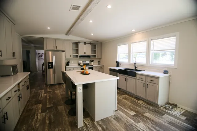a kitchen that has a lot of counter space and a sink
