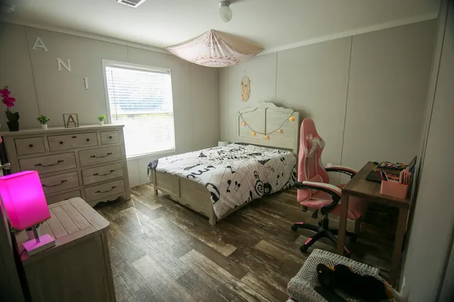 a bedroom with a bed a desk and chair