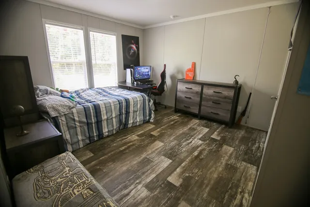 a bed sitting in a bedroom next to a window