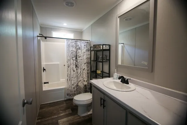 a bathroom with a sink toilet and shower