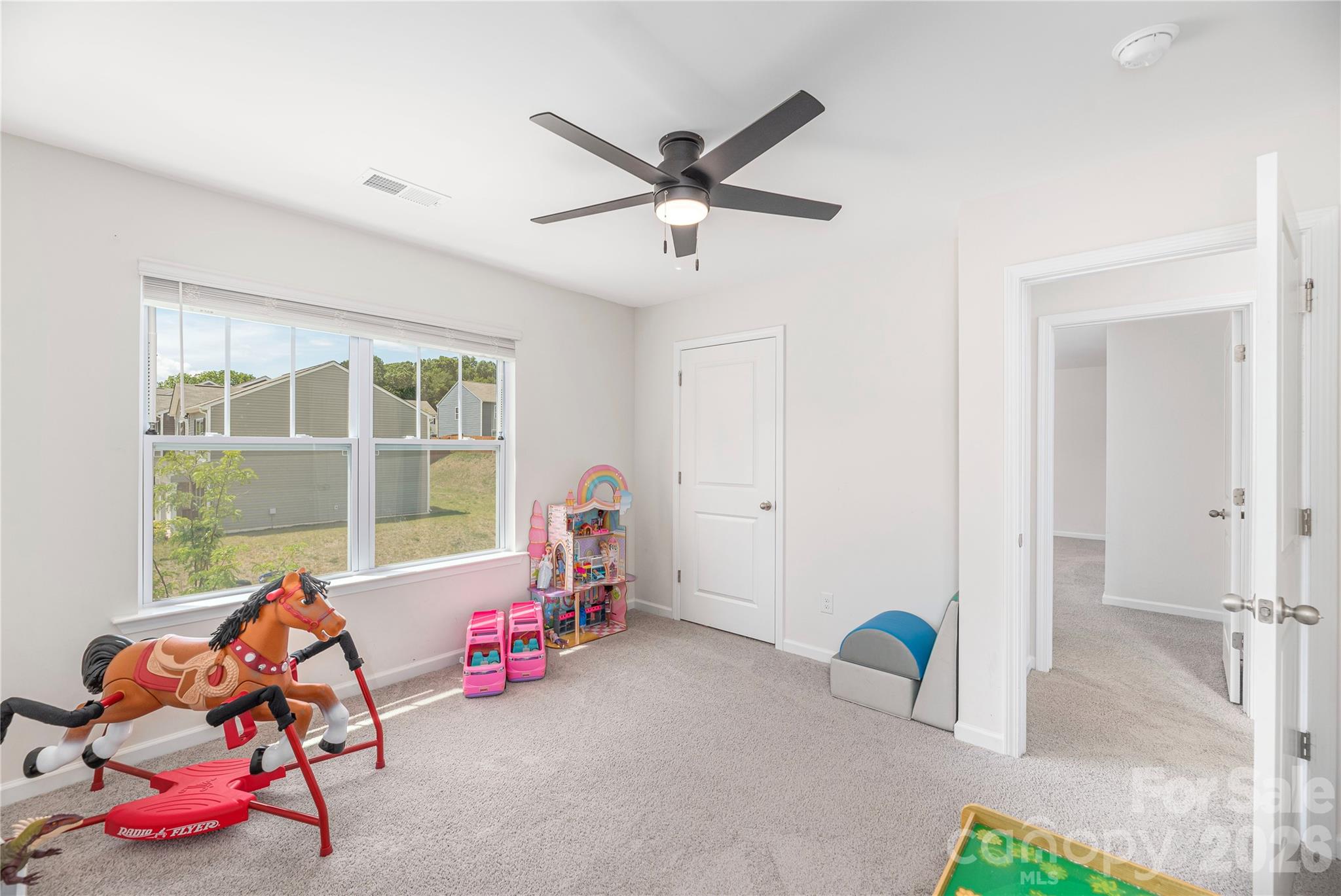 8 Madelyn Drive Clyde, NC 28721 - Photo 24 of 43 a living room with a ceiling fan and a window
