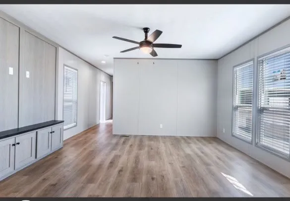 wooden floor in an empty room with a window