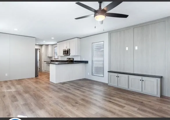 a view of a kitchen with a sink and cabinets