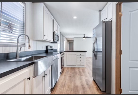 4343 Katy Hockley Road, Unit 162 Katy, TX 77493 - Photo 5 of 8 a kitchen with white cabinets and stainless steel appliances