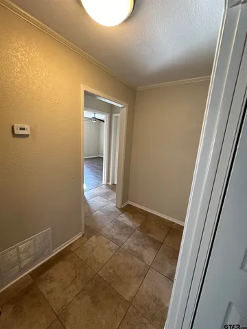 a view of a livingroom with wooden floor and a sink