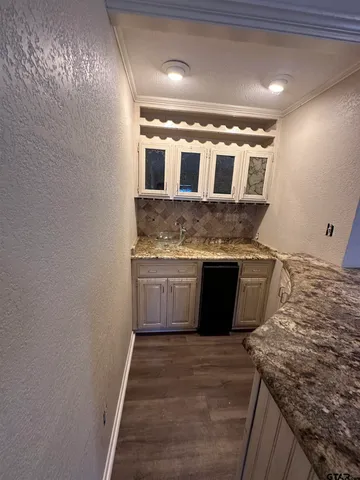 a kitchen with a stove and a more cabinets