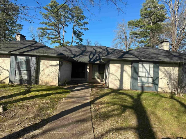a view of a house with a large tree