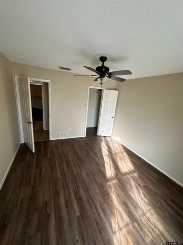 a view of empty room with wooden floor