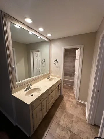 a bathroom with a double vanity sink and mirror