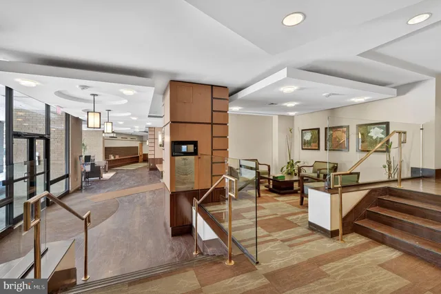 a living room with furniture a flat screen tv and a table