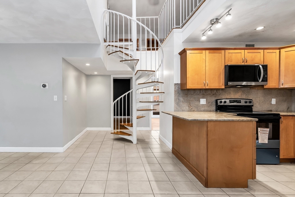 21 Margin Street, Unit 33 Lynn, MA 01905 - Photo 12 of 30 a view of kitchen with sink microwave and cabinets