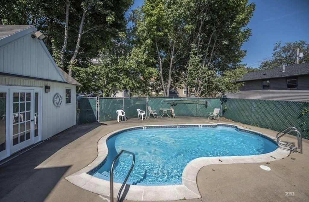21 Margin Street, Unit 33 Lynn, MA 01905 - Photo 28 of 30 a view of a swimming pool with a patio
