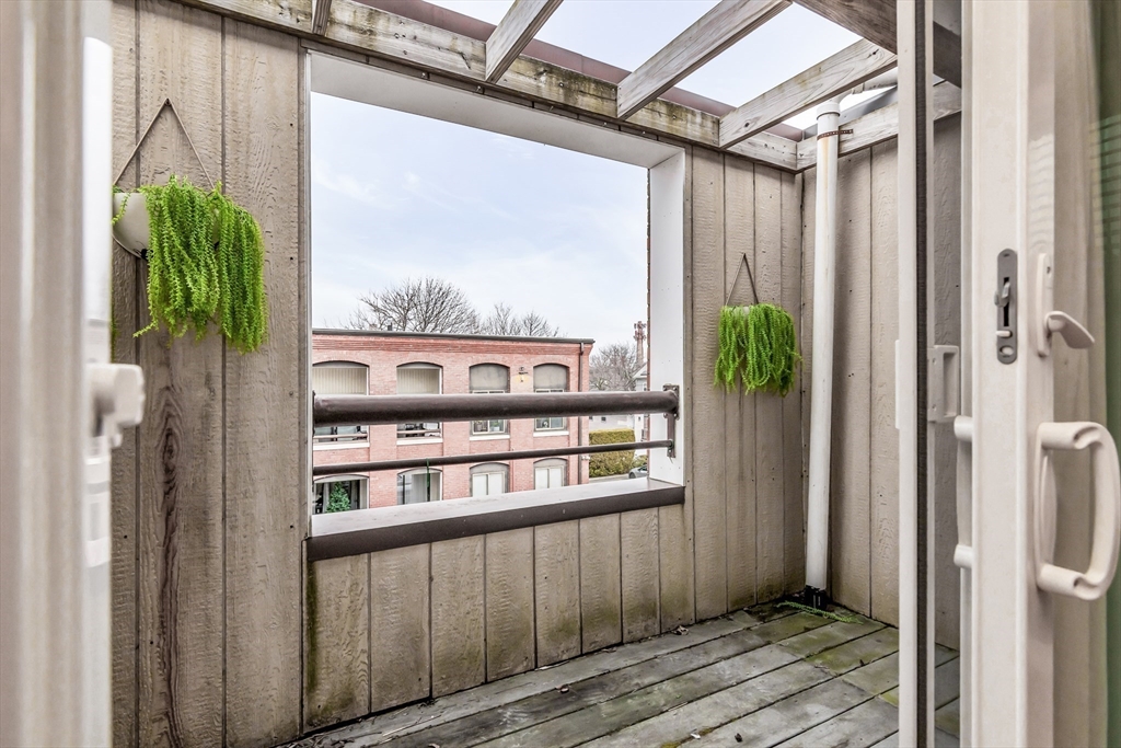 21 Margin Street, Unit 33 Lynn, MA 01905 - Photo 4 of 30 a view of a balcony from a hallway
