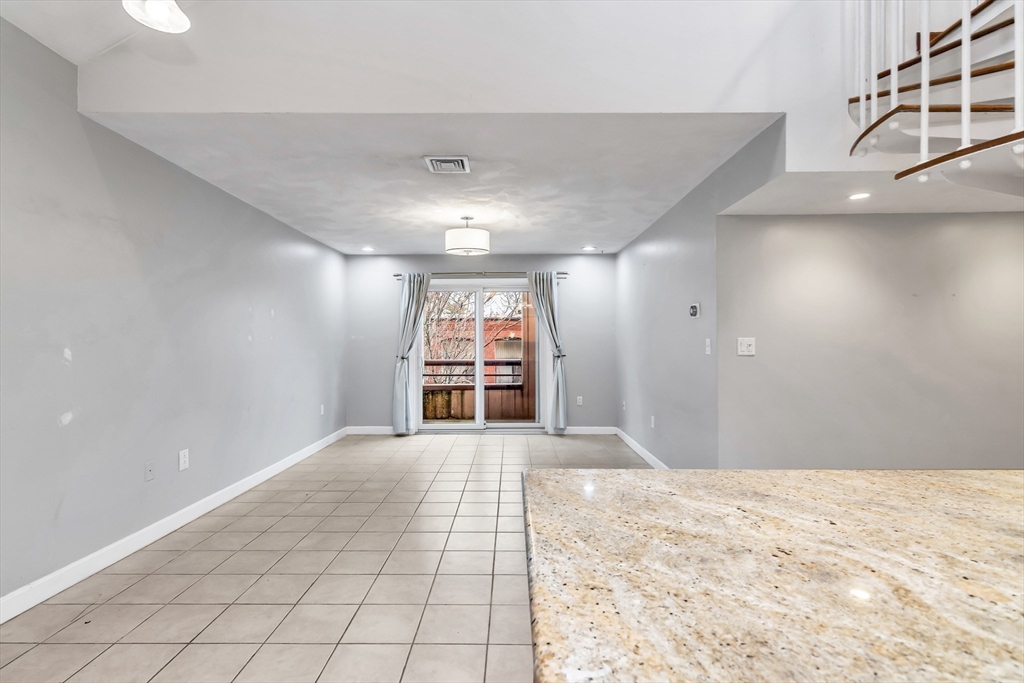 21 Margin Street, Unit 33 Lynn, MA 01905 - Photo 9 of 30 a view of a big room with windows and chandelier fan
